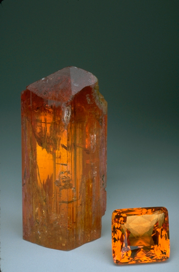 Imperial topaz crystal and a faceted gem at the smithsonian institute