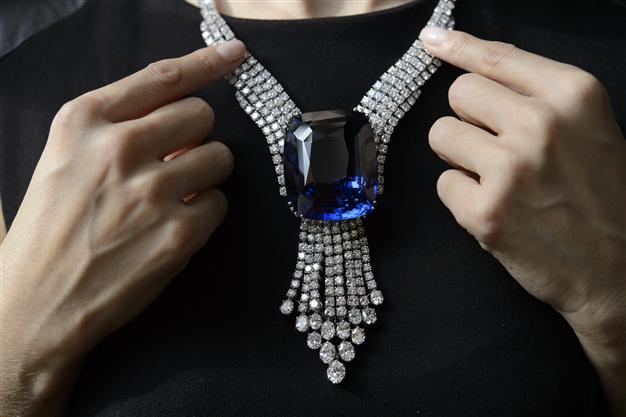 A Christie's employee holds The Blue Belle of Asia a 392.52 carats sapphire