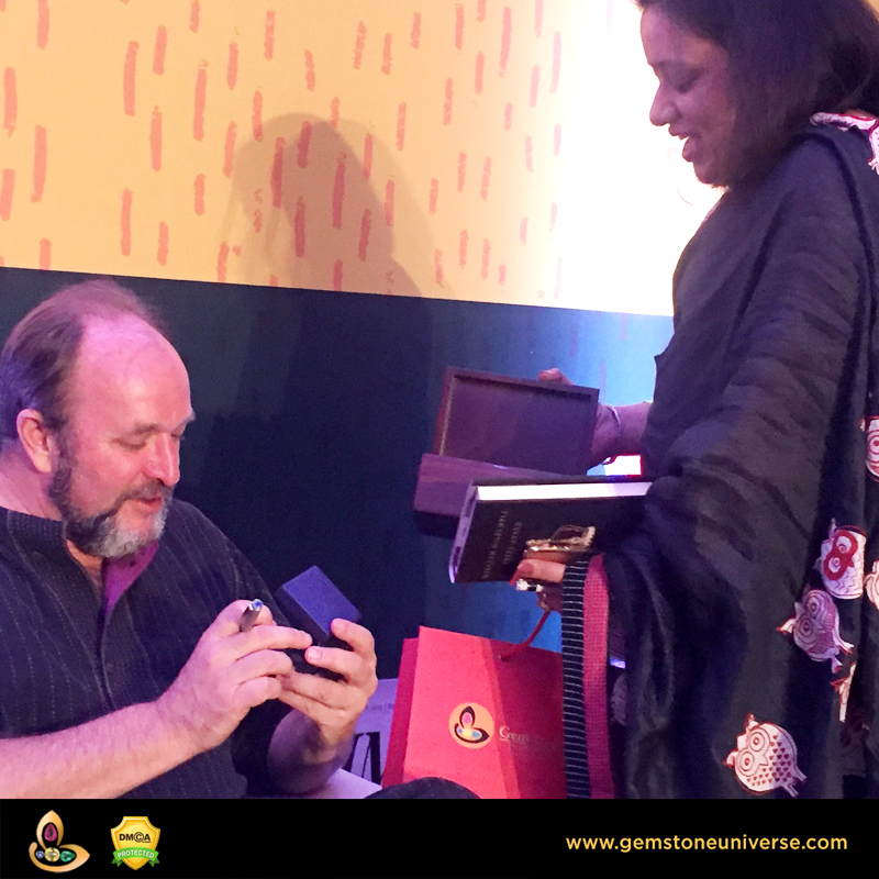 William Dalrymple admiring a bespoke Gemstone Pendant from the Gemstoneuniverse collection of Fine Jyotish Gemstones